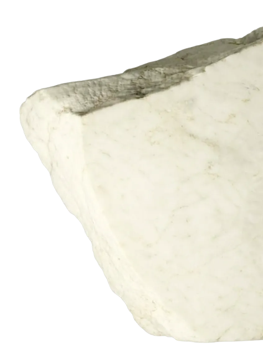 Close-up of a white marble slab with a rough, uneven surface and faint texture.