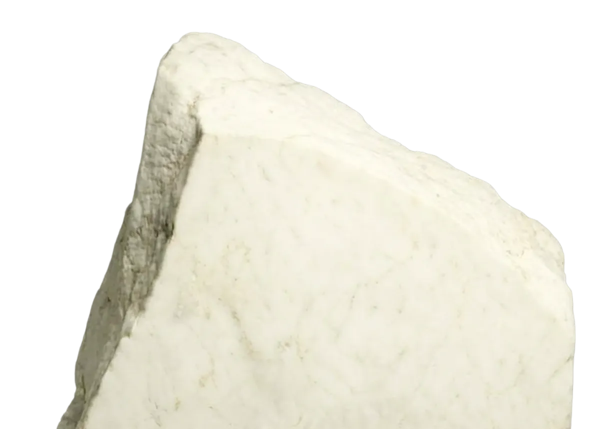 A rough, irregular piece of white marble with natural veins and texture.